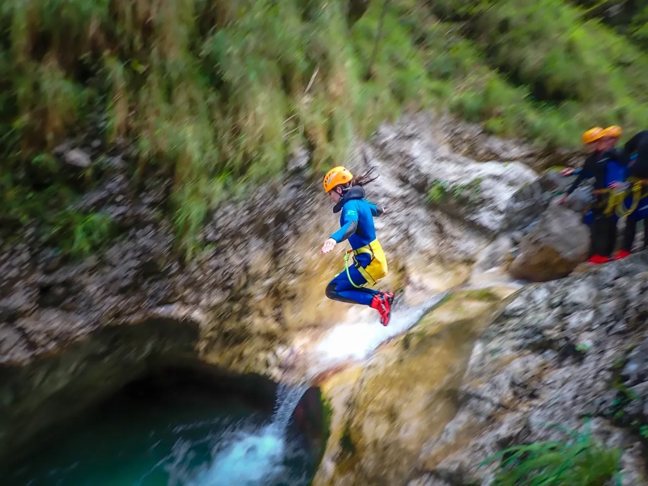 Jumping into emerald pools on canyoning Slovenia